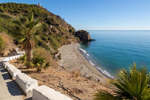 Sandy beach of Playa de Maro, near Nerja, Andalusia, Spain with calm Mediterranean Sea, out of