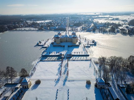 Moritzburg Castle on the castle island surrounded by the frozen castle pond, Moritzburg, Saxony,