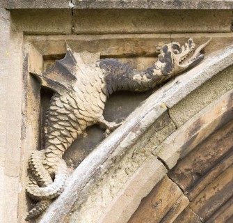 Mythological folklore figure of a griffin dragon carved in stone on the entrance doorway to the