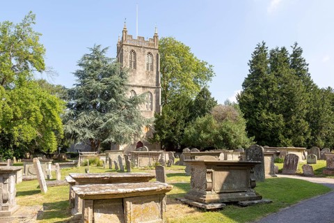Tower of church of Saint Mary, Berkeley, Gloucestershire, England, UK gravestones and chest tombs