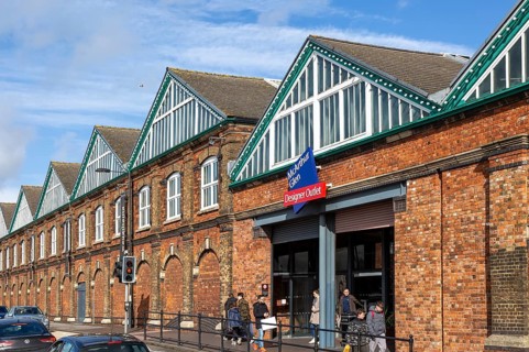 McArthur Glen designer outlet west entrance into former railway works, Swindon, Wiltshire, England,