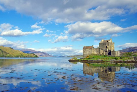 Eilean Donan Castle reflected in the water on a calm evening, filming location for James Bond,