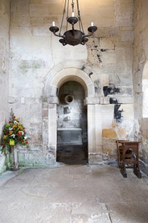 Interior stone arch leading to altar inside Saxon church of Saint Laurence, Bradford on Avon,