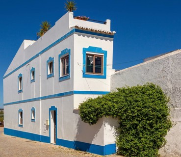 Traditional architecture building style house with whitewashed walls and blue painted features,
