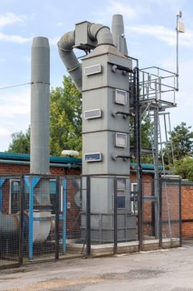 Exhaust gas air purification tower at small specialist steel firm, Calne, England, UK