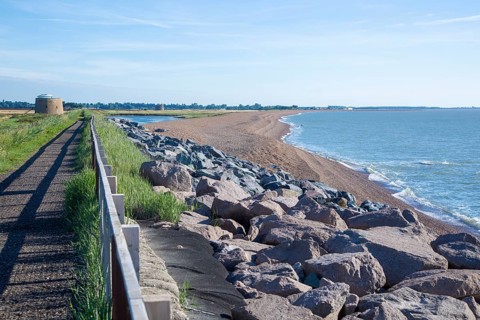 Shingle bay bar and lagoon landforms with rock armour coastal defences at Bawdsey, Suffolk,