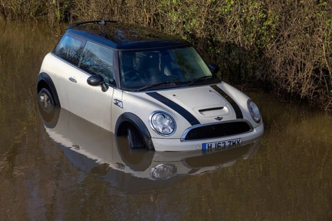 Mini Cooper S car stuck in River Avon flood water, Kellaways bridge, Wiltshire, England, UK