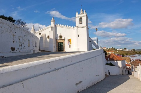Historic whitewashed church Igreja Matrix in medieval village of Mertola, Baixo Alentejo, Portugal,