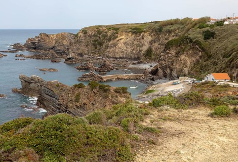 Rocky rugged coastline near fishing port village of Azenha do Mar, Alentejo Littoral, Portugal,