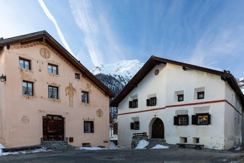 Historic houses, sgraffito, facade decorations, window shutters, mountain peaks with snow, winter,