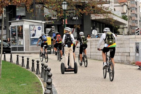 Tourists on a cruise ship during a shore excursion with bicycles and Segway, Praca Marques de