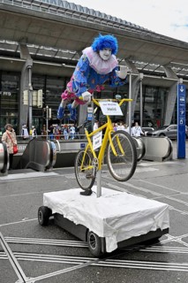Carnival reveller flying hero on bicycle