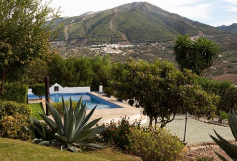 Swimming pool in garden small hotel view to Alcaucin village and Maroma mountain, Sierra de Tejeda,