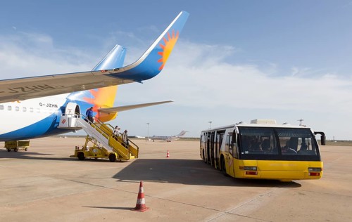 Jet2 package holiday plane passengers disembarking at the airport Faro, Algarve, Portugal with