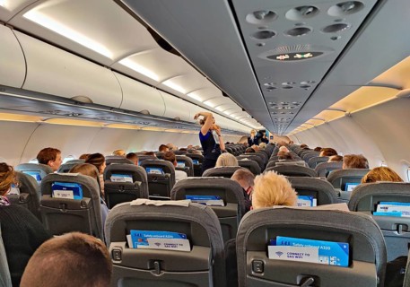 Passengers in the interior of an aircraft during the safety demonstration by the flight attendants
