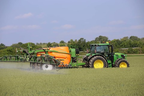 A farmer from the Schmitt vegetable farm in Hockenheim drives his tractor with a crop protection