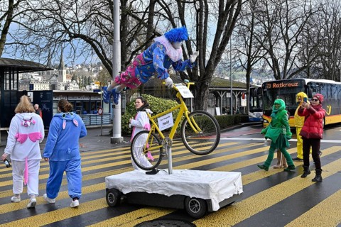 Carnival reveller flying hero on bicycle