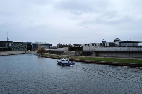 A police boat travels up the River Spree close to the German Bundestag building on a day of