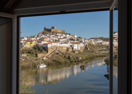 Historic hilltop walled medieval village of Mertola with castle, on the banks of the river Rio