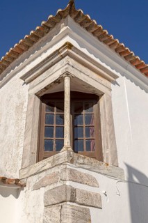 Window balcony and architectural detail of building inside historic walled hilltop village of