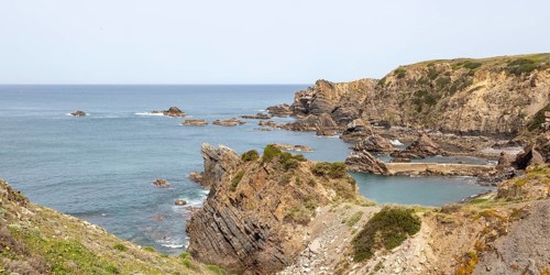 Rocky rugged coastline near fishing port village of Azenha do Mar, Alentejo Littoral, Portugal,