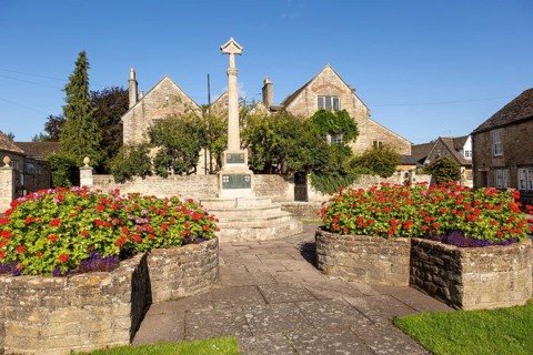 Historic Cotswold stone buildings and war memorial in Canon Square, Melksham, Wiltshire, England,