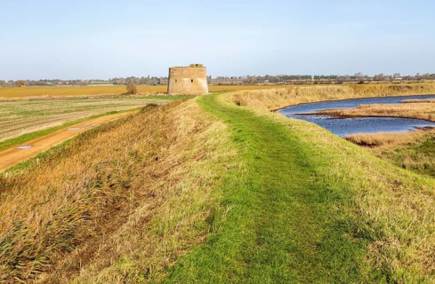 Martello tower Z from footpath on sea wall flood defence embankment, Alderton, Suffolk, England, UK
