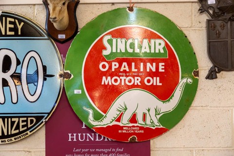 Vintage Sinclair Oplaine motor oil metal advertising sign on display at auction