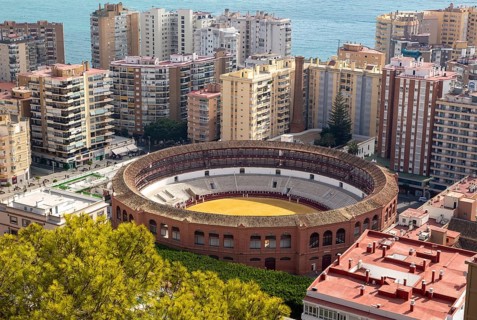 Historic bullring in city of Malaga surrounded by high rise apartments, Malaga, Andalusia, Spain,