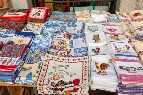 Display of tea towel textile souvenir products of butterflies and fish on sale, city of Evora, Alto