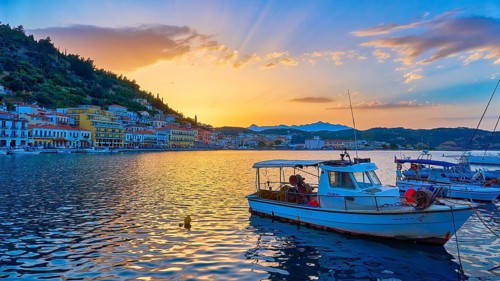 Harbour view at sunset with boats and glowing water reflections, Gythio, Mani, Peloponnese, Greece,