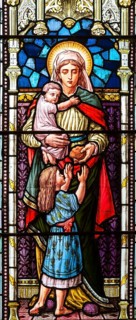 Stained glass window depicting Caritas or Charity, Bedingfield church, Suffolk, England, UK c 1881