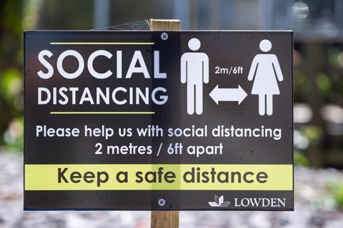 Social Distancing 2 metres apart information notice sign in Lowden garden centre shop, Wiltshire,