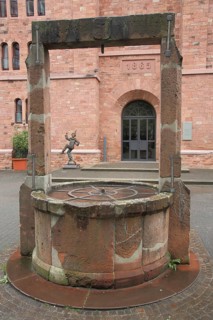Castle fountain with beams and carnival figure, year, draw well, provisions magazine, historic city