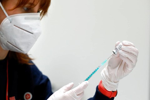 Drawing up a syringe with the Biontech Pfizer active ingredient Comirnaty against Covid19 in a