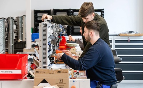 An electronics apprentice assembles a motor protection relay at a Deutsche Bahn training centre,
