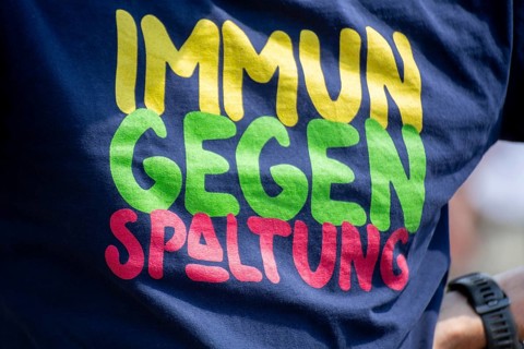 Immune to division. A man wears a T-shirt with this inscription at a peace demonstration in