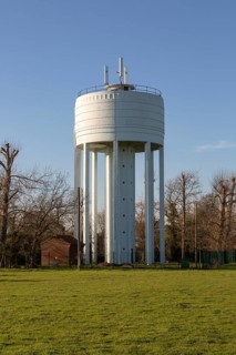 White concrete water storage tower at St Michael South Elmham, Suffolk, England, UK