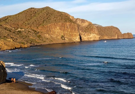 Man and woman holding hands walking on beach, Isleta del Moro, Cabo de Gata natural park, Almeria,