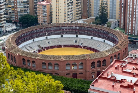 Historic bullring in city of Malaga surrounded by high rise apartments, Malaga, Andalusia, Spain,