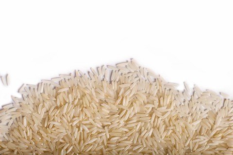 Texture of basmati rice isolated on white background. Top view. Copy space
