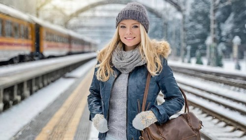 AI generated, A young blonde woman wants to travel and waits for the train at the station, 20, 25,
