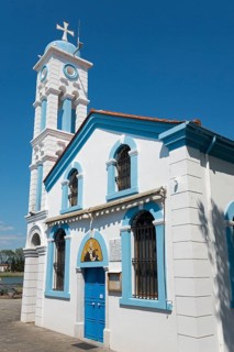 A white church with blue sky and decorative tower, Monastery of St Nicholas, Monastery of Agios