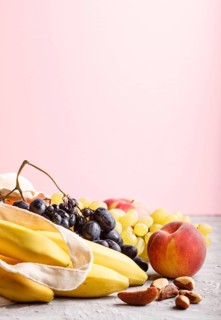 Fruits in reusable cotton textile white bag. Zero waste shopping, storage and recycling concept,