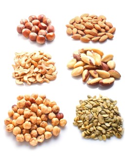 Piles of various nuts and seeds isolated on white background. hazelnut, brazil nut, almond, pumpkin