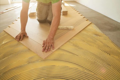 Craftsmen laying herringbone parquet professionally