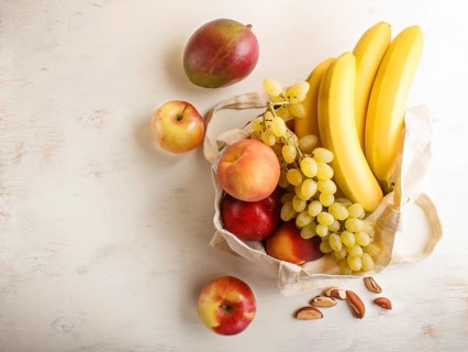 Fruits in reusable cotton textile white bag. Zero waste shopping, storage and recycling concept,
