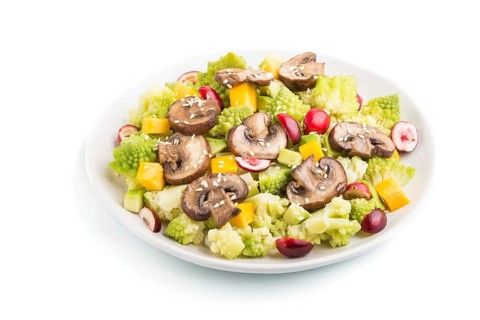 Vegetarian salad from romanesco cabbage, champignons, cranberry, avocado and pumpkin isolated on a