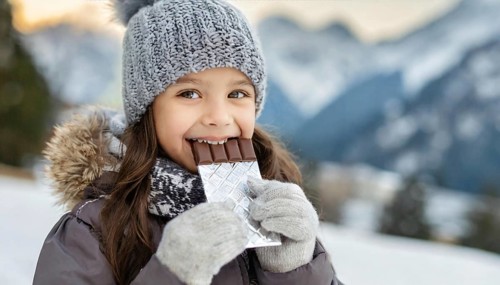 KI generated, Young girl, 10, years, eating a bar of chocolate, one person, outdoor shot, ice,
