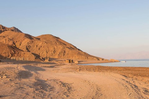 The coastline of the Red Sea and the mountains in the background, sunset. Egypt, the Sinai